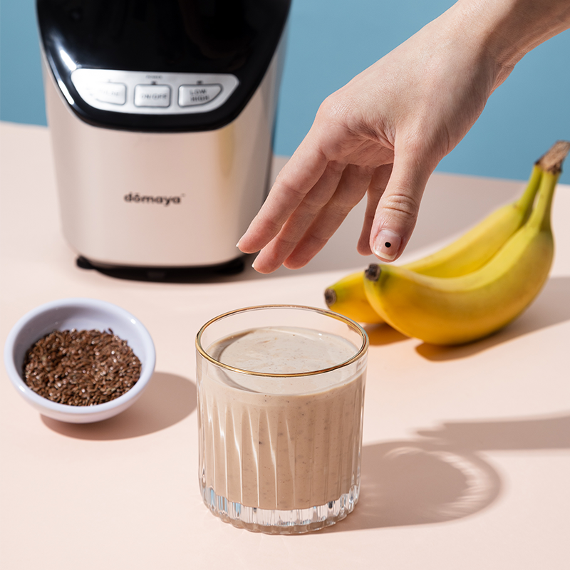 banana almond flax power smoothie with the domaya high power nutri blender in the back